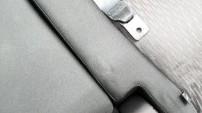The back of the rear row of seats, 2nd row, left, Nissan Rogue 17-20, black fabric, with a belt, armrest and lower frame, is wrinkled