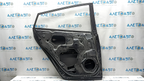 The bare rear left door of a Toyota Prius 50 16-20 is dented