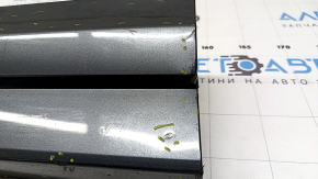 The lower front left door trim of the Audi Q3 8U 16-18 is worn and dented