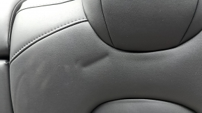 The back of the rear row of seats, left, Tesla Model 3 18-23, black leather, with a belt and heating, is wrinkled
