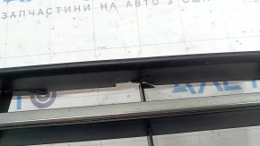 The central grille of the front bumper of the VW Passat b8 16-19 USA is chrome, cracked, fragments are missing