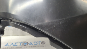 The rear bumper of a Toyota Sienna 21-26 is bent, scuffed, and the mount is broken