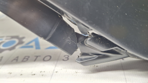 The rear bumper of a Toyota Sienna 21-26 is bent, scuffed, and the mount is broken