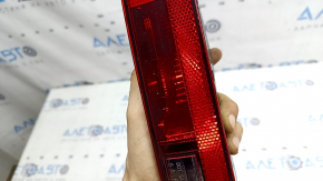 The left rear bumper light of the Audi Q5 80A 21-25 is worn and chipped