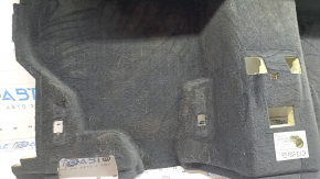 The rear floor covering of a BMW X3 F25 11-17 is black and needs cleaning. The foam rubber is torn and 2 mat fasteners are missing