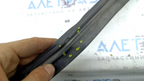 The front bumper lip of the Honda Insight 19-22 has broken fasteners, is worn and deformed