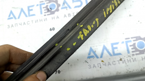 The front bumper lip of the Honda Insight 19-22 has broken fasteners, is worn and deformed