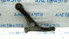 The lower front left control arm of a Hyundai Sonata 11-15 hybrid has torn silent blocks and a broken stopper