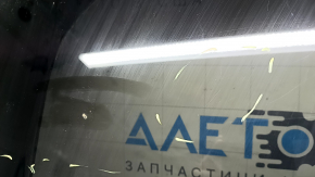 The sunroof glass of Toyota Prius V 12-17 has scratches, glue, and peeling varnish