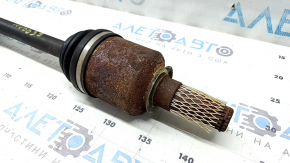 The front left half shaft of a Toyota Camry 92-01 is rusty, with play in the inner CV joint