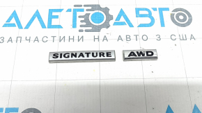 The paint on the SIGNATURE AWD emblem on the Mazda CX-5 22-25 trunk door is peeling off