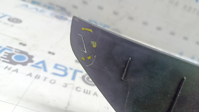 The upper right trunk door trim for a Ford Edge 15-24 is black, the fastener is broken, the plastic has turned white