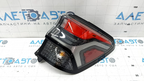 The outer right wing light of a Subaru Forester 25-26 is worn and has a spider web