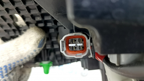 The outer right wing light of a Subaru Forester 25-26 is worn and has a spider web