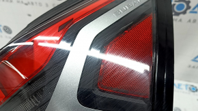 The outer right wing light of a Subaru Forester 25-26 is worn and has a spider web