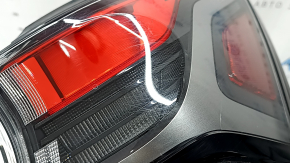The outer right wing light of a Subaru Forester 25-26 is worn and has a spider web