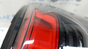 The outer right wing light of a Subaru Forester 25-26 is worn and has a spider web