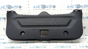 The lower trim of the trunk door of the Subaru Forester 25-26 is black, worn, scratches, needs cleaning, the fastener is drilled out