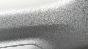 The lower trim of the trunk door of the Subaru Forester 25-26 is black, worn, scratches, needs cleaning, the fastener is drilled out