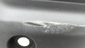 The lower trim of the trunk door of the Subaru Forester 25-26 is black, worn, scratches, needs cleaning, the fastener is drilled out