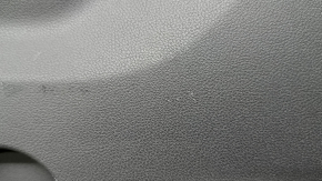 The lower trim of the trunk door of the Subaru Forester 25-26 is black, worn, scratches, needs cleaning, the fastener is drilled out