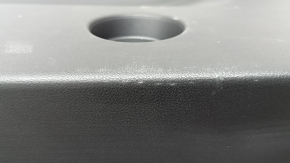 The lower trim of the trunk door of the Subaru Forester 25-26 is black, worn, scratches, needs cleaning, the fastener is drilled out