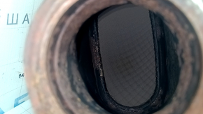 The exhaust pipe with a catalytic converter for Infiniti QX50 19-22 has a torn mesh and is rusty