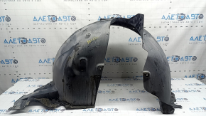 The front right fender liner of a VW Tiguan 22-24 is dented, cracked, and the mount is broken