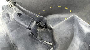 The front right fender liner of a VW Tiguan 22-24 is dented, cracked, and the mount is broken