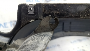 The front right fender liner of a VW Tiguan 22-24 is dented, cracked, and the mount is broken