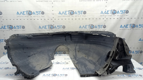 The front right fender liner of a VW Tiguan 22-24 is dented, cracked, and the mount is broken