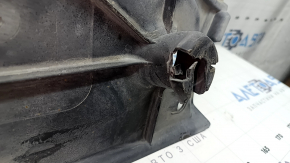 The right underbody protection of the VW Tiguan 18-24 is worn, has tears, cracks, and is dented