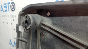 The right underbody protection of the VW Tiguan 18-24 is worn, has tears, cracks, and is dented