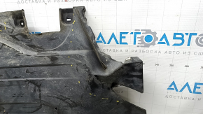 The rear left underbody protection of BMW X5 G05 19-23 is dented and torn