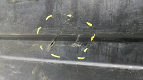 The rear left underbody protection of BMW X5 G05 19-23 is dented and torn