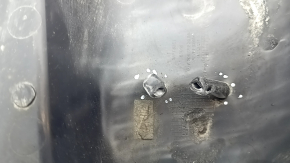 The rear left control arm cover under the spring of a Mercedes C-class W205 16-21 has broken fastenings, scratches, and a tear
