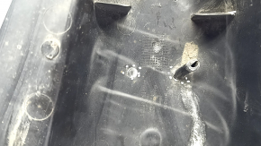 The rear right control arm cover under the spring of a Mercedes C-class W205 16-21 has broken fasteners, scratches, and a tear