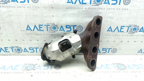 The exhaust manifold with a catalytic converter for a Nissan Kicks 20-25 is rusty and the studs are sawed off