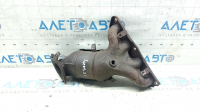 The exhaust manifold with a catalytic converter for a Nissan Kicks 20-25 is rusty and the studs are sawed off