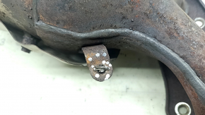 The exhaust manifold with a catalytic converter for a Nissan Kicks 20-25 is rusty and the studs are sawed off