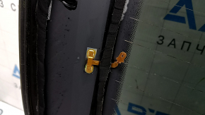 The rear glass of the trunk door of a Porsche Macan 15-16 with a trunk release button is worn, the heating tracks are oxidized