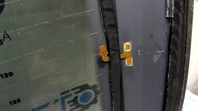 The rear glass of the trunk door of a Porsche Macan 15-16 with a trunk release button is worn, the heating tracks are oxidized