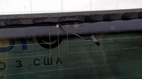 The rear glass of the trunk door of a Porsche Macan 15-16 with a trunk release button is worn, the heating tracks are oxidized