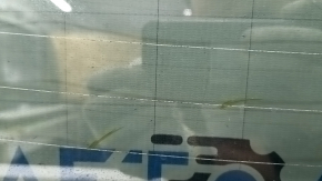 The rear glass of the trunk door of a Porsche Macan 15-16 with a trunk release button is worn, the heating tracks are oxidized