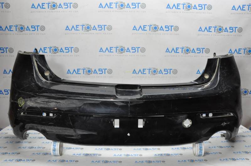 The rear bumper is bare and needs repair for a Mazda3 MPS 2009-2013. It's black and has a hole in it and a dent.