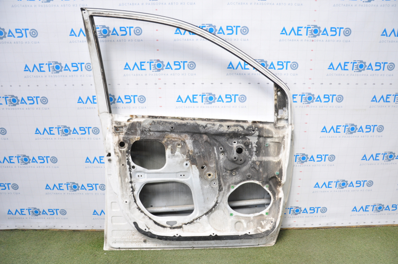 The door is bare, front left, Toyota Sienna 04-09, white, dented corner, bumps, burnt