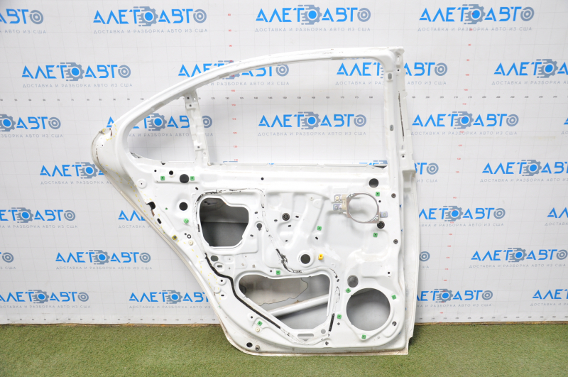The door is bare, rear left, Lexus LS460 LS600h 07-17, white, dented on the inside near the lock.
