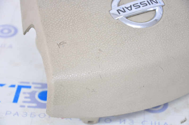 Driver's steering wheel airbag for a 2007-2009 Nissan Versa, beige, scratches