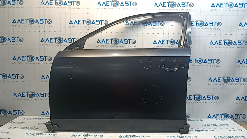 The front left door of a VW Passat b7 12-15 USA is bare and dented.