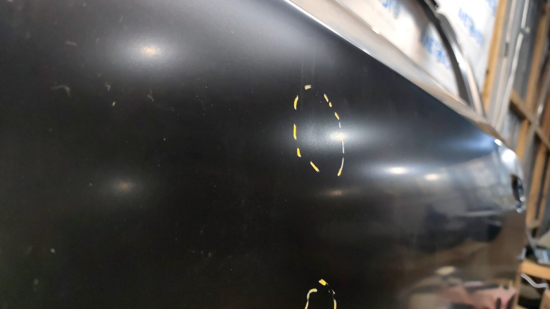 The front left door of a VW Passat b7 12-15 USA is bare and dented.